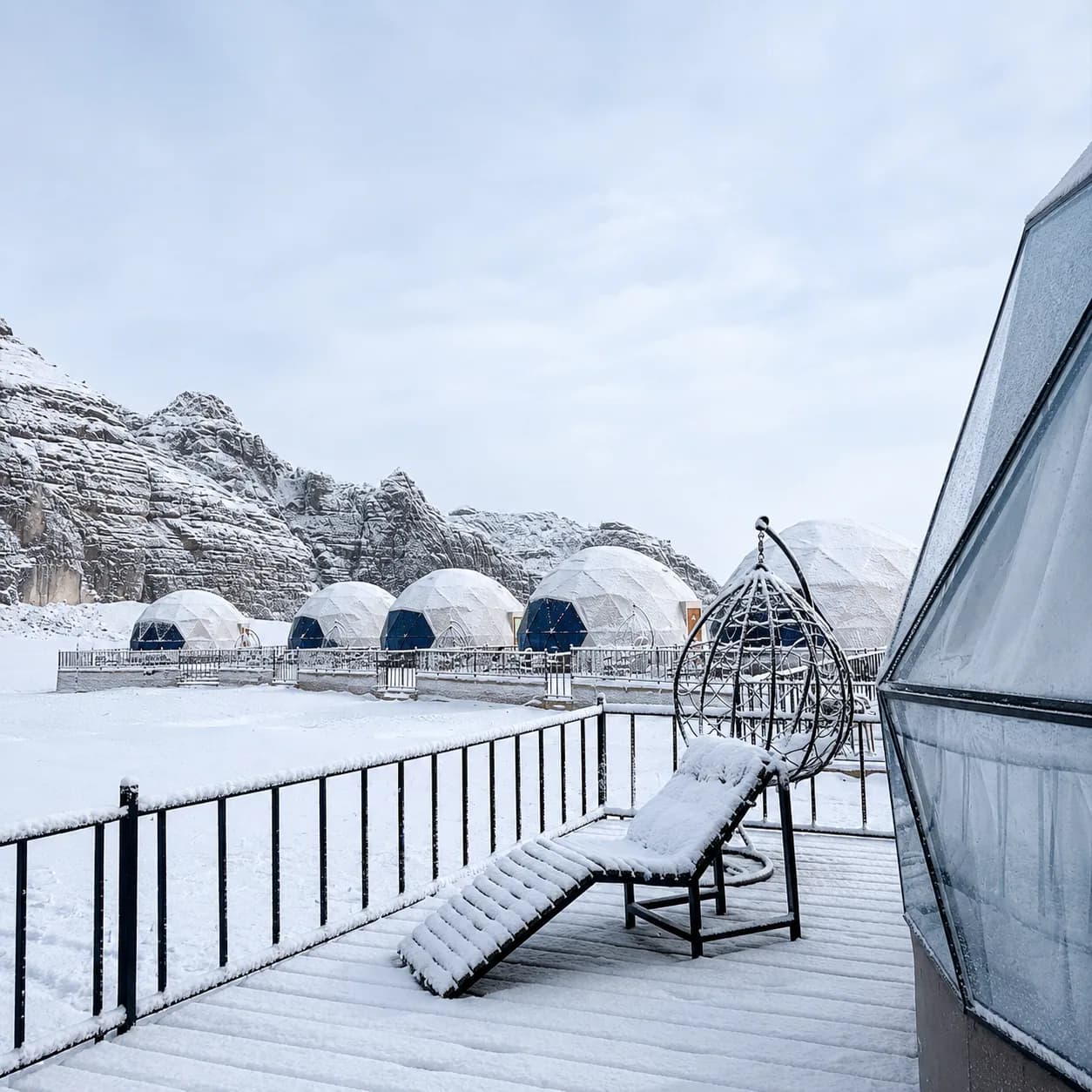 Jamal Rum Camp domes and deck with a cool mountain backdrop.