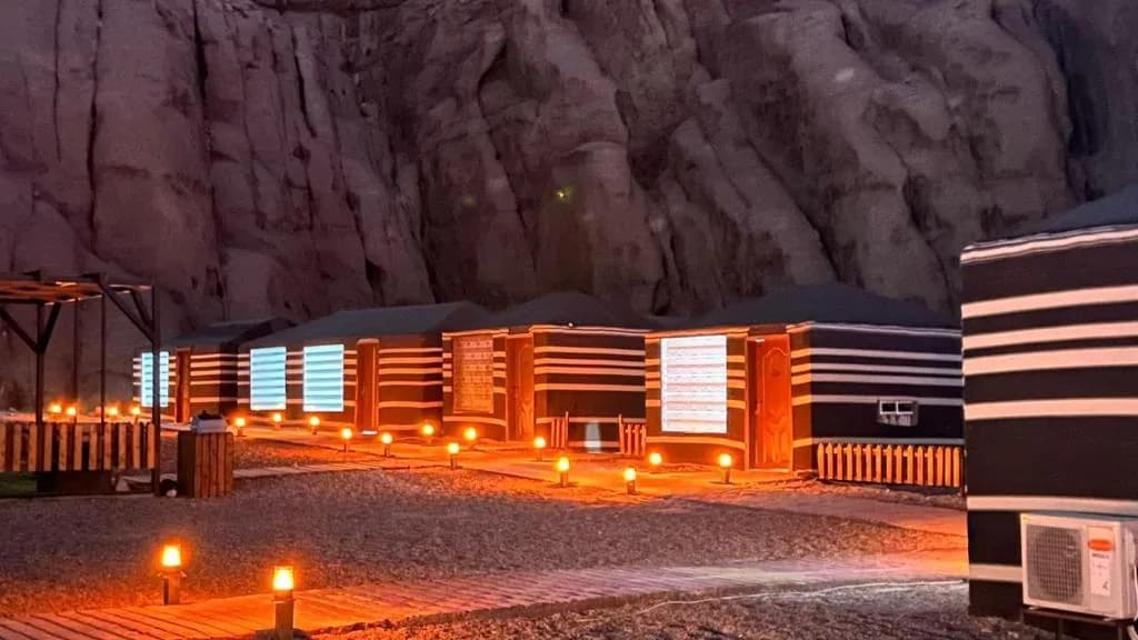 Jamal Rum Camp cabins and warm lights at night.