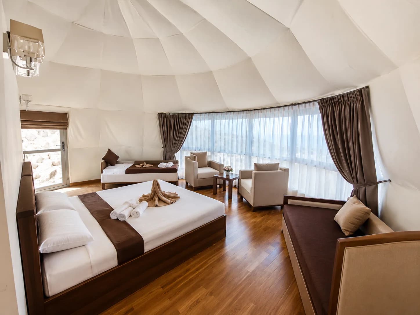 Spacious Jamal Rum Camp room with seating and desert-inspired decor.